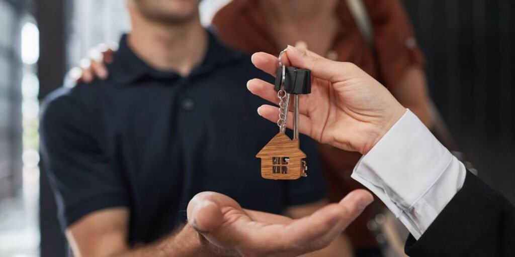 Couple accept keys after LIFT Open Market Shared Equity Scotland